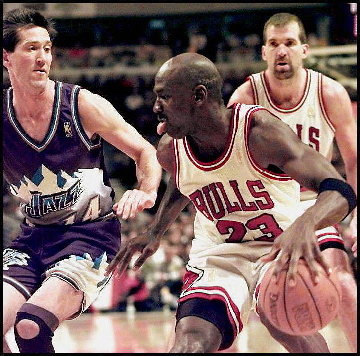 Michael Jordan (C) of the Chicago Bulls tries to d