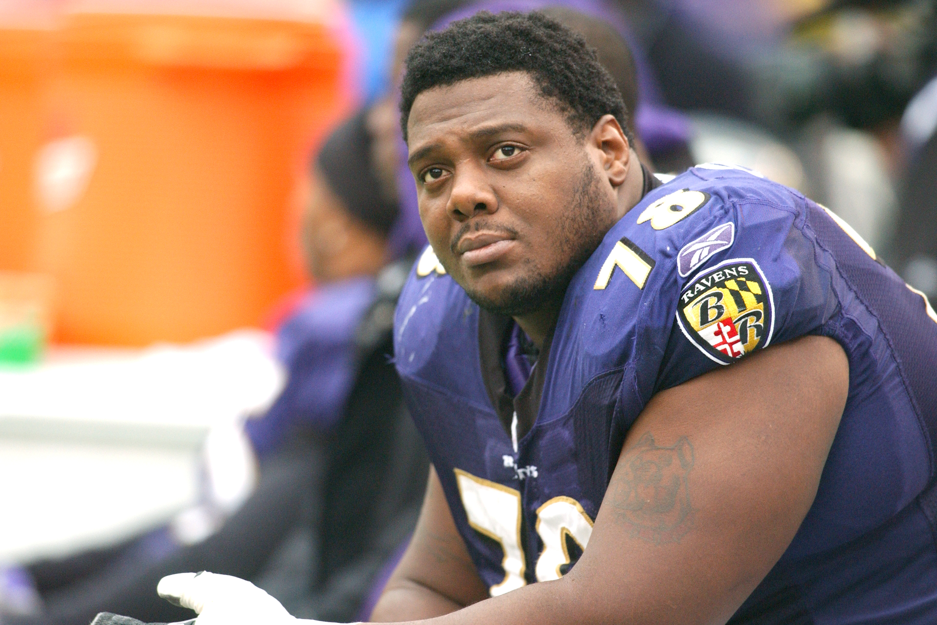 Ravens player Orlando Brown sits on the bench during a game