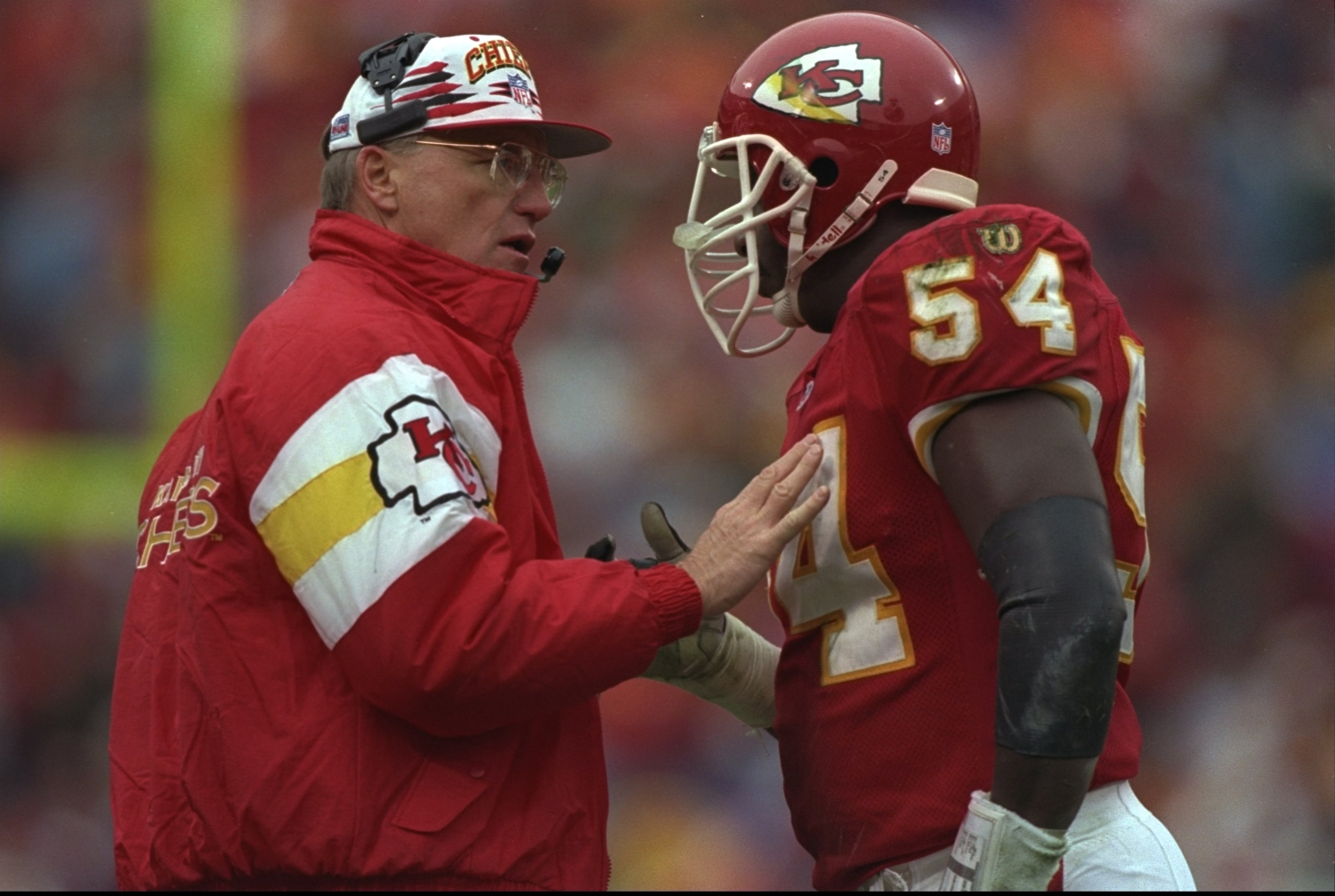 Head coach Marty Schottenheimer of the Kansas City Chiefs talks with his linebacker Tracy Simien during a game against the Green Bay Packers.
