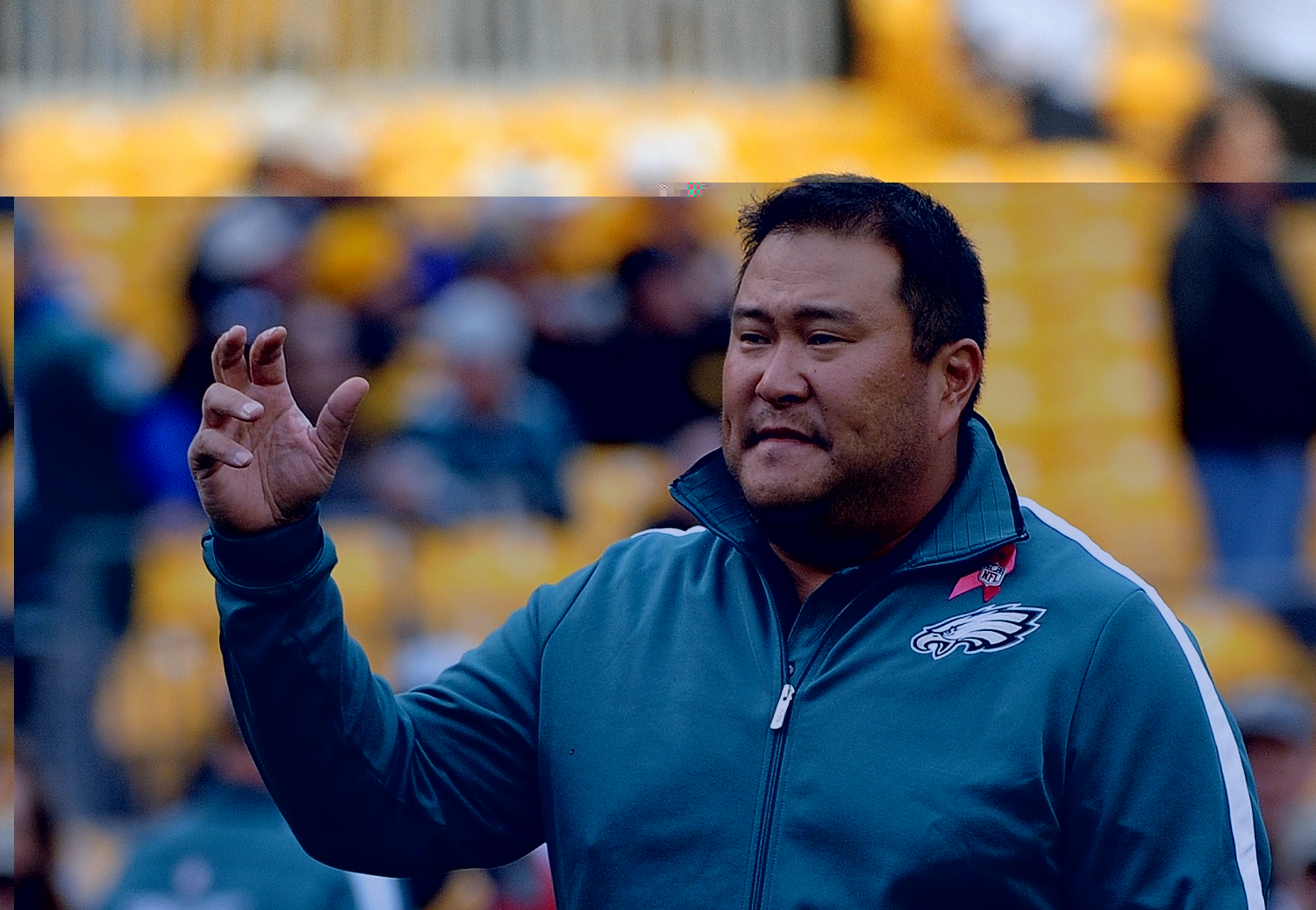 Offensive line assistant Eugene Chung of the Philadelphia Eagles looks on during warmups prior to a game against the Pittsburgh Steelers on Oct. 7, 2012,