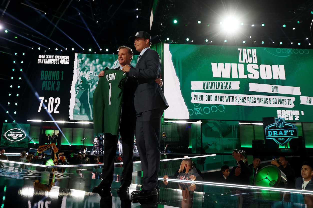 Zach Wilson stands onstage with NFL Commissioner Roger Goodell after being drafted second by the New York Jets during round one of the 2021 NFL Draft at the Great Lakes Science Center on April 29, 2021 in Cleveland, Ohio.