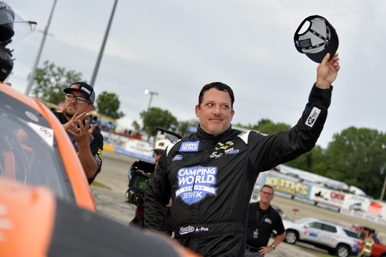 Tony Stewart waves to fans before climbing into his car for the Superstar Racing Experience event at Slinger Speedway on July 10, 2021 in Slinger, Wisconsin.