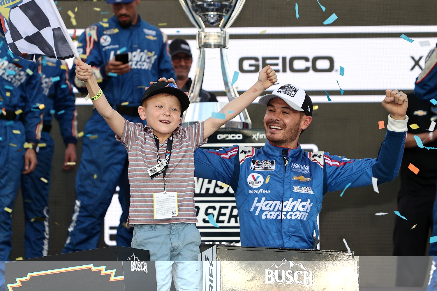 Kyle Larson, driver of the No. 5 Chevrolet, celebrates with his son, Owen, in victory lane after winning the NASCAR Cup Series Championship at Phoenix Raceway on Nov. 7, 2021.