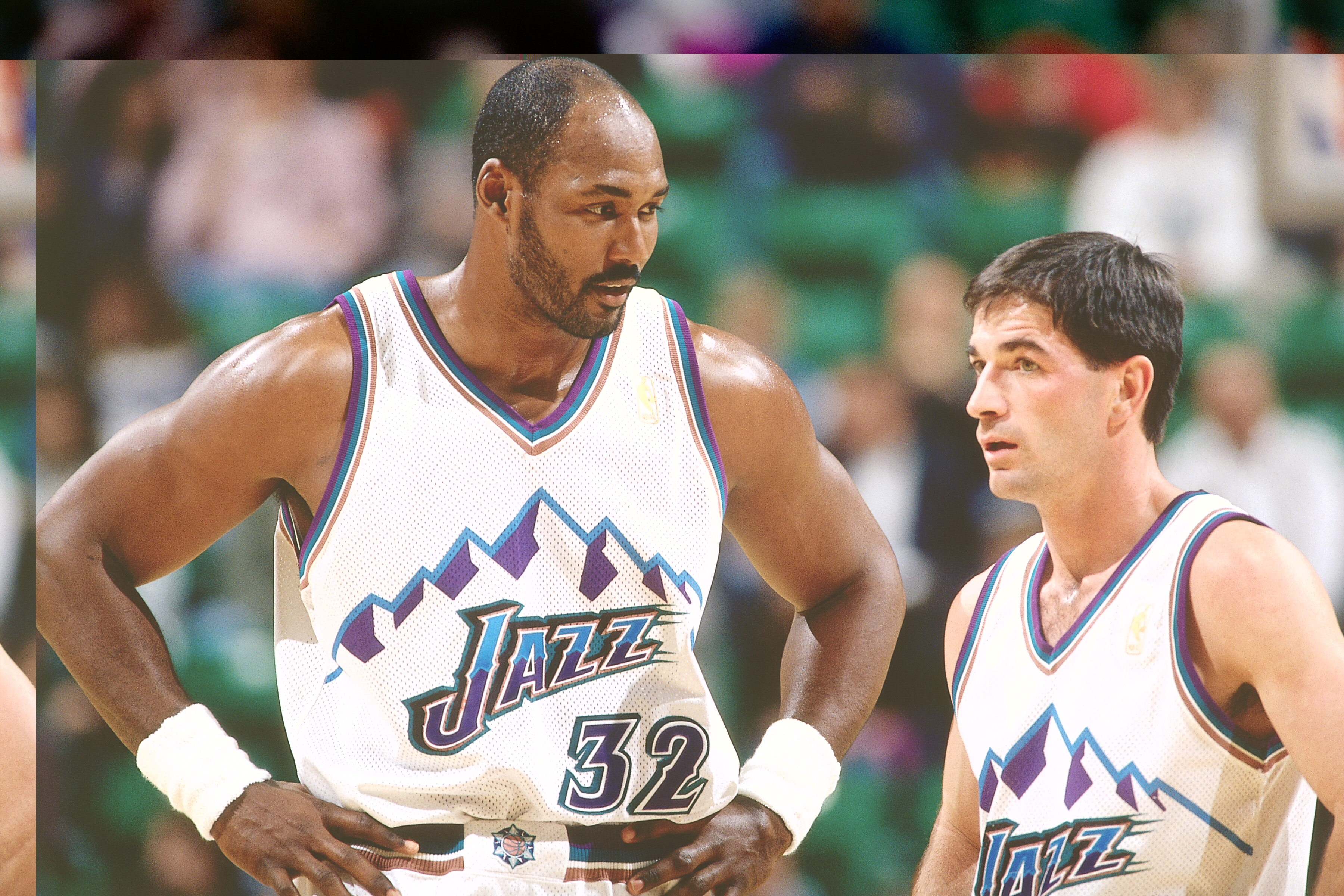 Utah Jazz greats Karl Malone and John Stockton talk during an NBA game in 1997