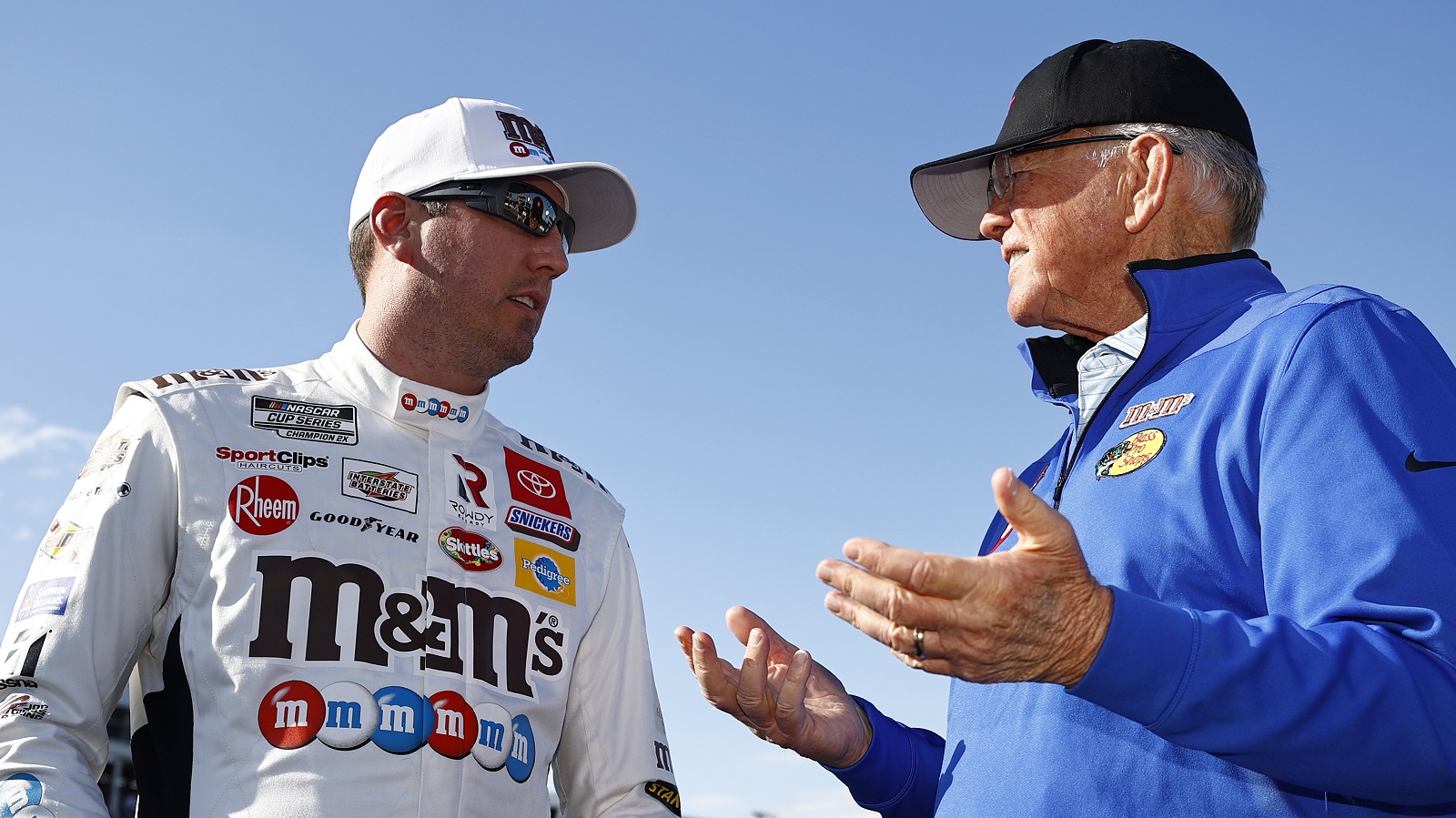 Kyle Busch, driver of the No. 18 Toyota, and Hall of Famer and team owner Joe Gibbs talk on the grid prior to the NASCAR Cup Series Coca-Cola 600 at Charlotte Motor Speedway on May 30, 2021. | Jared C. Tilton/Getty Images