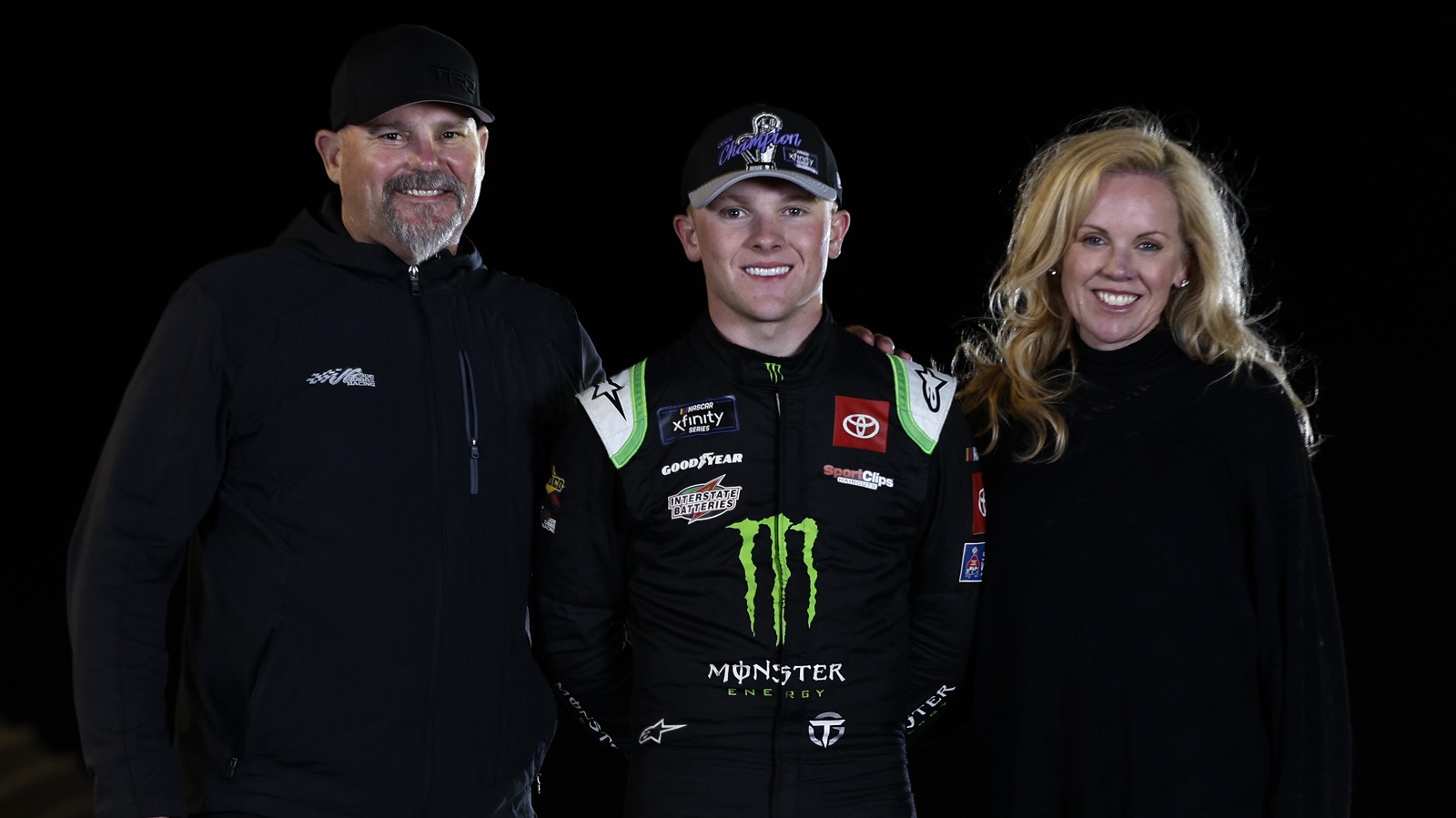 Ty Gibbs poses with his father, Coy Gibbs and mother, Heather Gibbs after winning the NASCAR Xfinity Series championship at Phoenix Raceway on Nov. 5, 2022. | Meg Oliphant/Getty Images