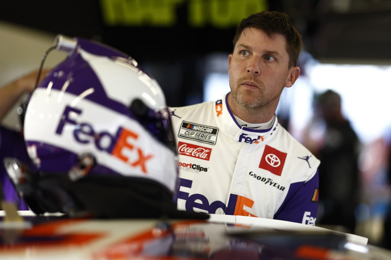 Denny Hamlin looks on in the garage area during practice for the NASCAR Cup Series Daytona 500 on Feb. 17, 2023. | Chris Graythen/Getty Images
