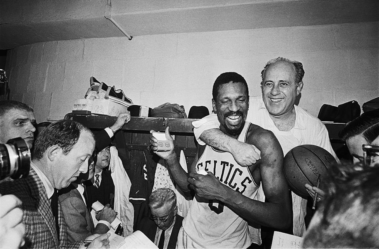 Bill Russell (L) and Red Auerbach (R) embrace after winning an NBA championship.