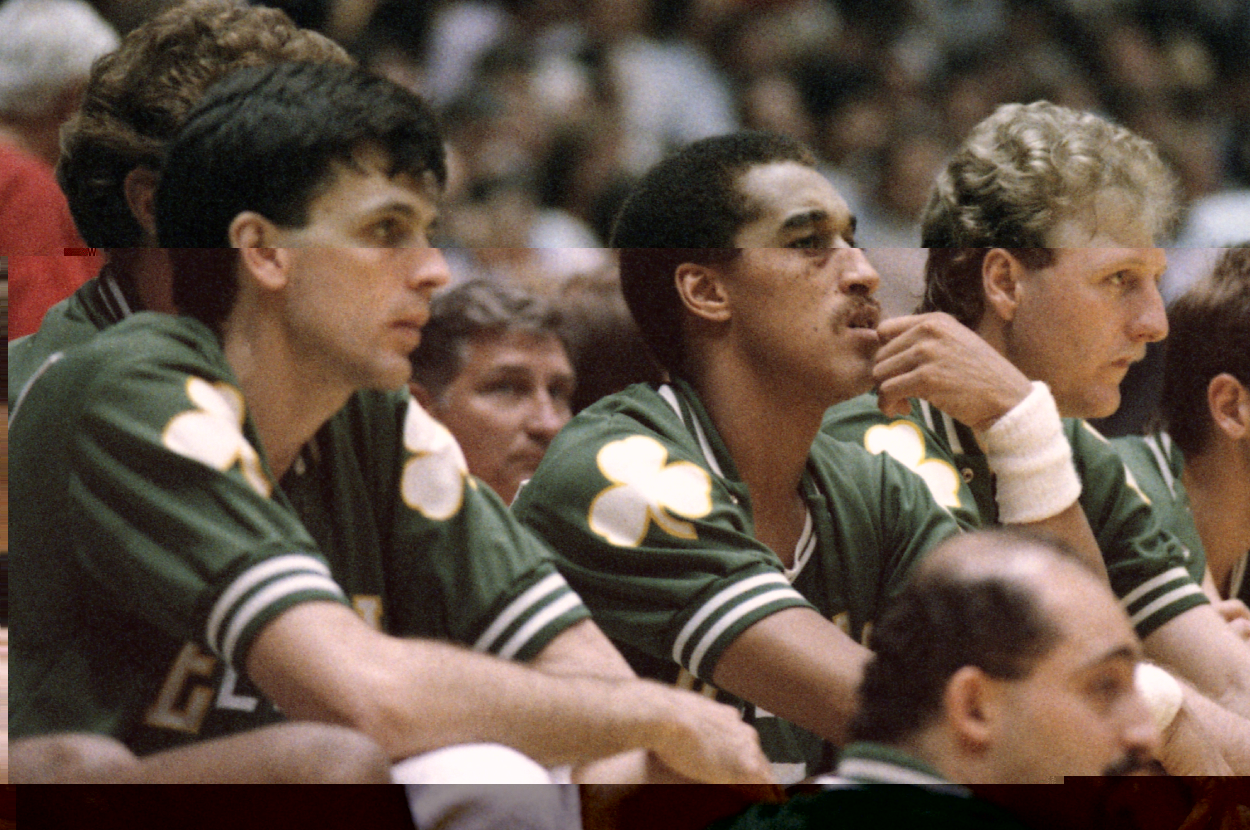 Kevin McHale, Dennis Johnson, and Larry Bird watch from the bench.